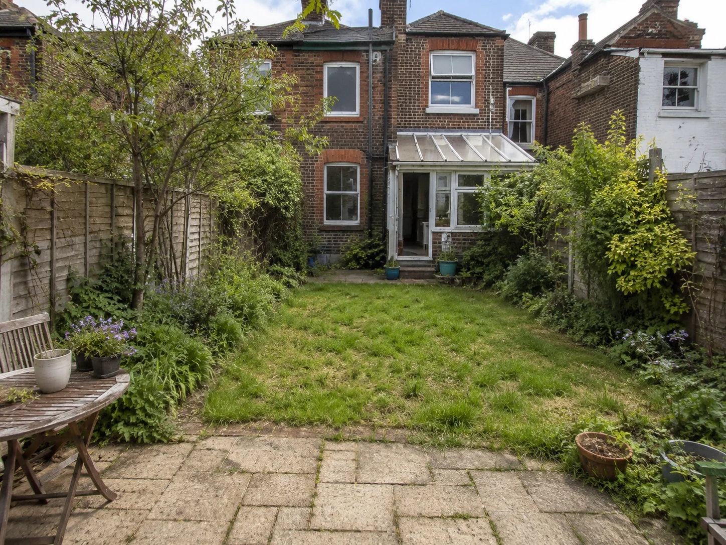 Illustrative British garden before a landscaping refresh